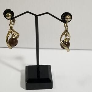 one inch clip on gold tone dangle brown cats eye earrings